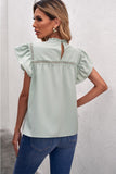 ruffled crewneck sleeveless blouse